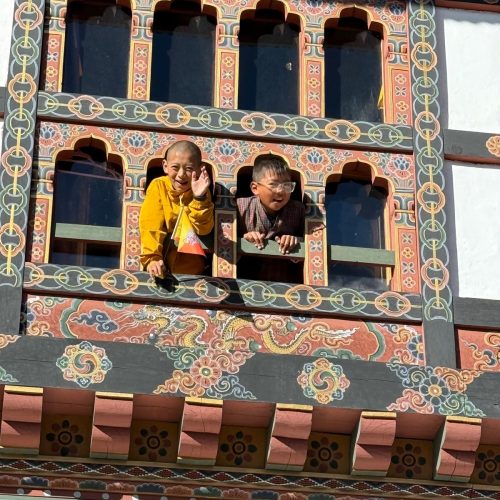Children Waving to runners from the window